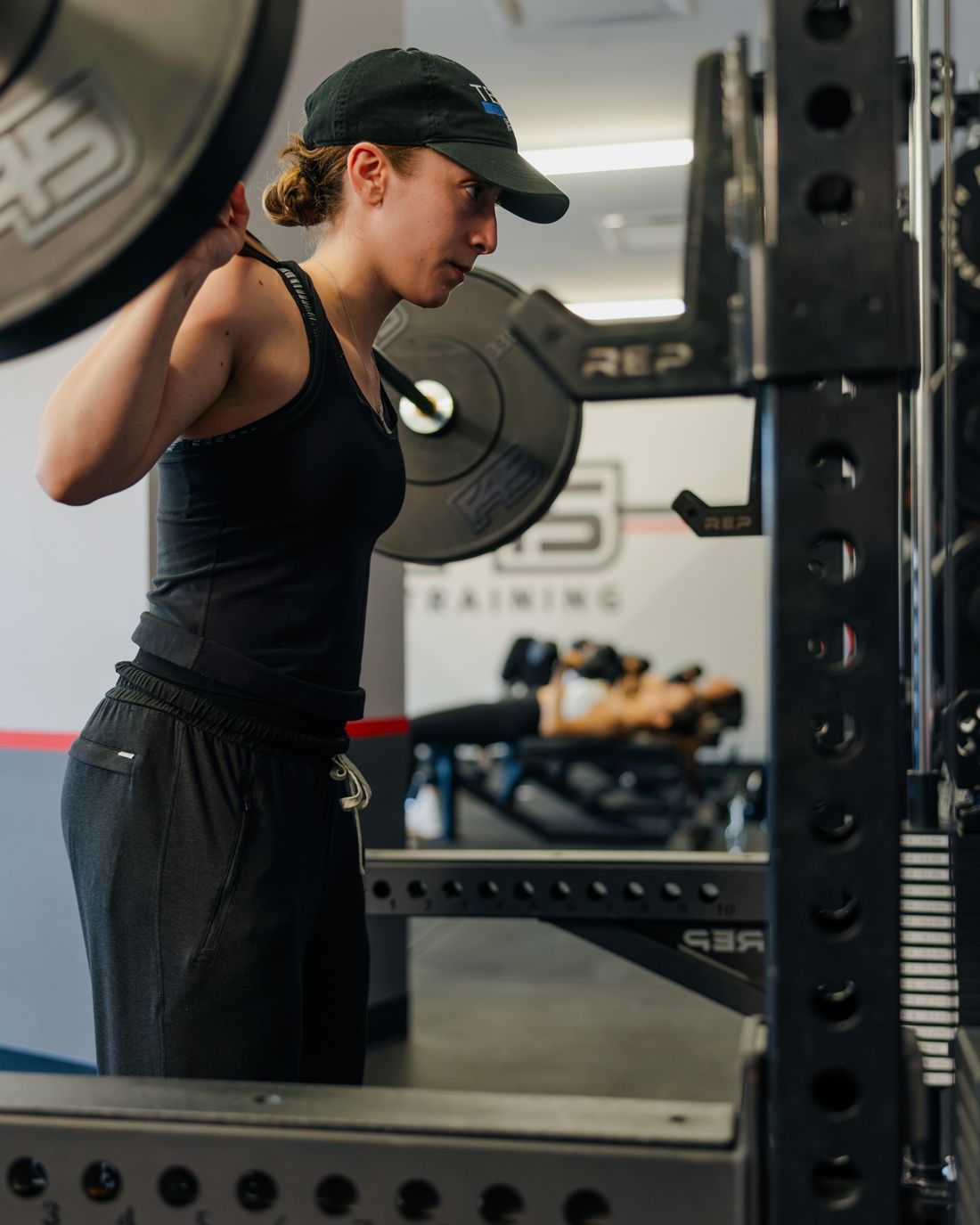 A member back-squatting under an F45 rack